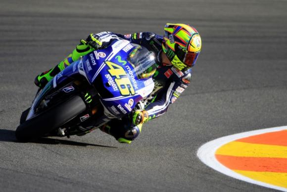 Yamaha MotoGP rider Valentino Rossi of Italy looks back as he races during the first free practice session ahead of the Valencia Motorcycle Grand Prix at the Ricardo Tormo racetrack in Cheste, near Valencia, November 7, 2014. REUTERS/Heino Kalis